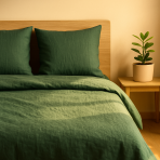 Leinen bettwäsche "Linen Dark Green". Leinen Bettwäsche, 135/140x200 cm, 200x200 cm, 200x220 cm, 220x240 cm. Dunkelgrünes leinenbettwäscheset auf weißem boden mit nachttisch und zimmerpflanze.